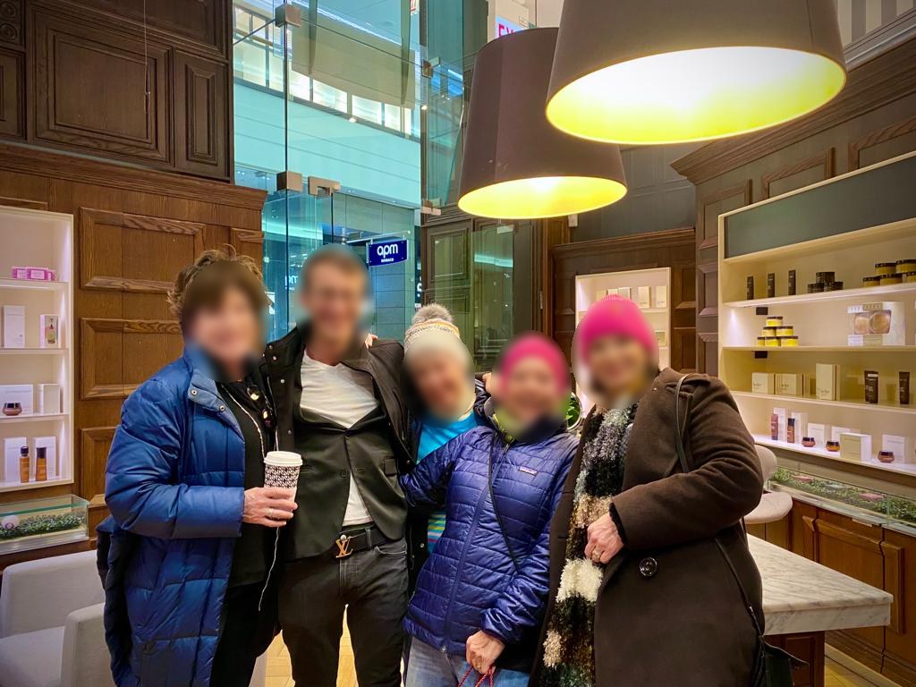 Group of customers and salesperson in the store